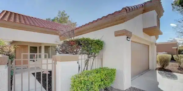 Image 4: A well-maintained stucco exterior with a tiled roo