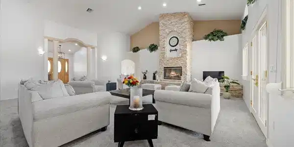 Image 4: Living area featuring light carpet, a fireplace, l