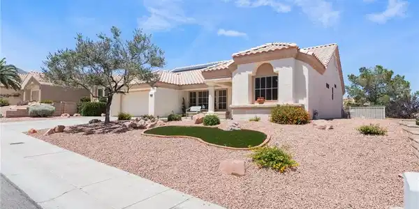 Image 3: A desert-friendly landscape surrounds this stucco-
