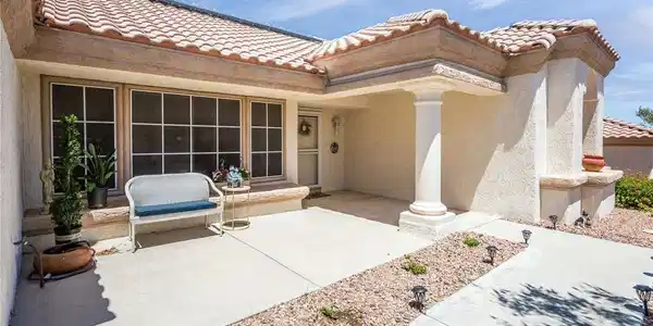 Image 4: A classic tiled roof crowns this inviting stucco h