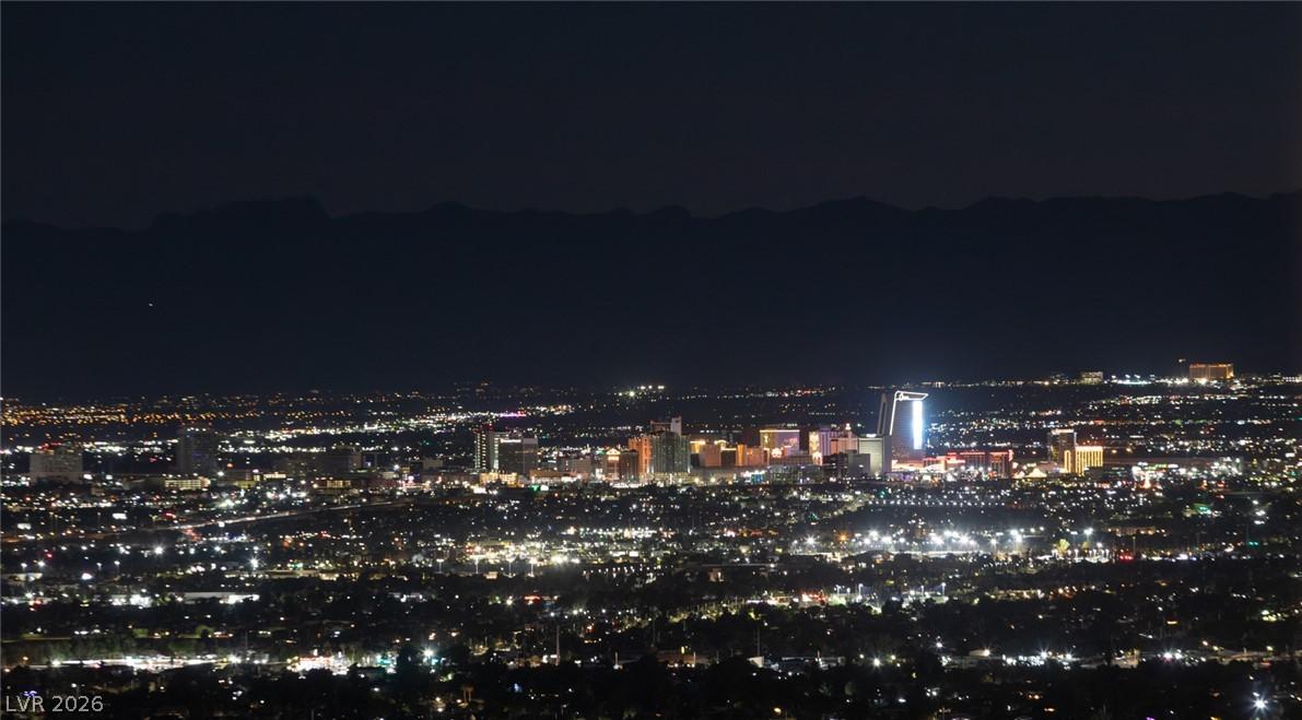 Image 2: The sparkling cityscape unfolds below, offering da