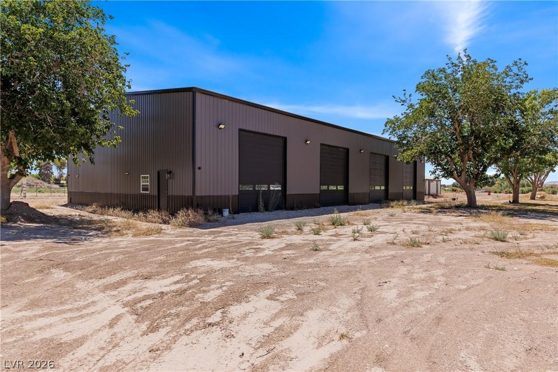 Image 2: A spacious, modern warehouse with multiple garage