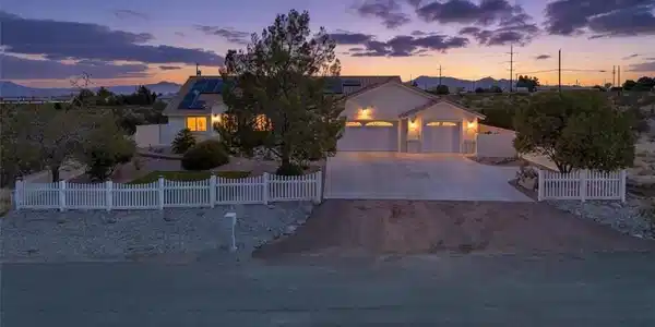 Image 3: An inviting front elevation glows at twilight, sho