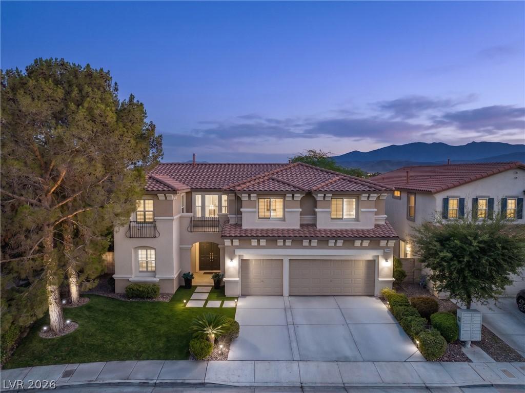 Image 2: An inviting exterior with illuminated landscaping