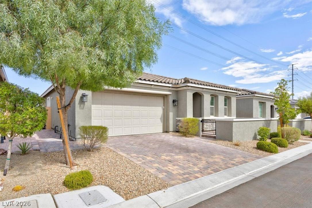 Image 2: A well-maintained stucco home with a tiled roof, p