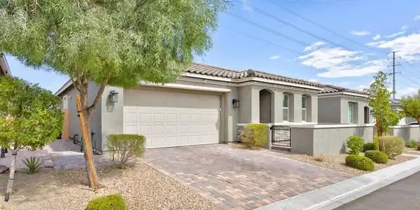 Image 2: A well-maintained stucco home with a tiled roof, p