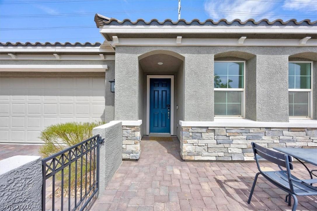 Image 3: A welcoming stone and stucco facade greets guests