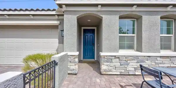 Image 3: A welcoming stone and stucco facade greets guests