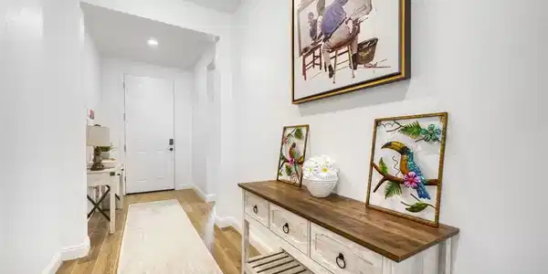 Image 3: This inviting hallway features bright walls and ri