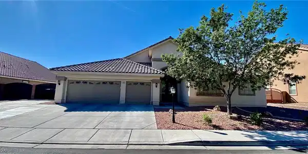 Image 2: Spanish tile roofing and a wide concrete driveway