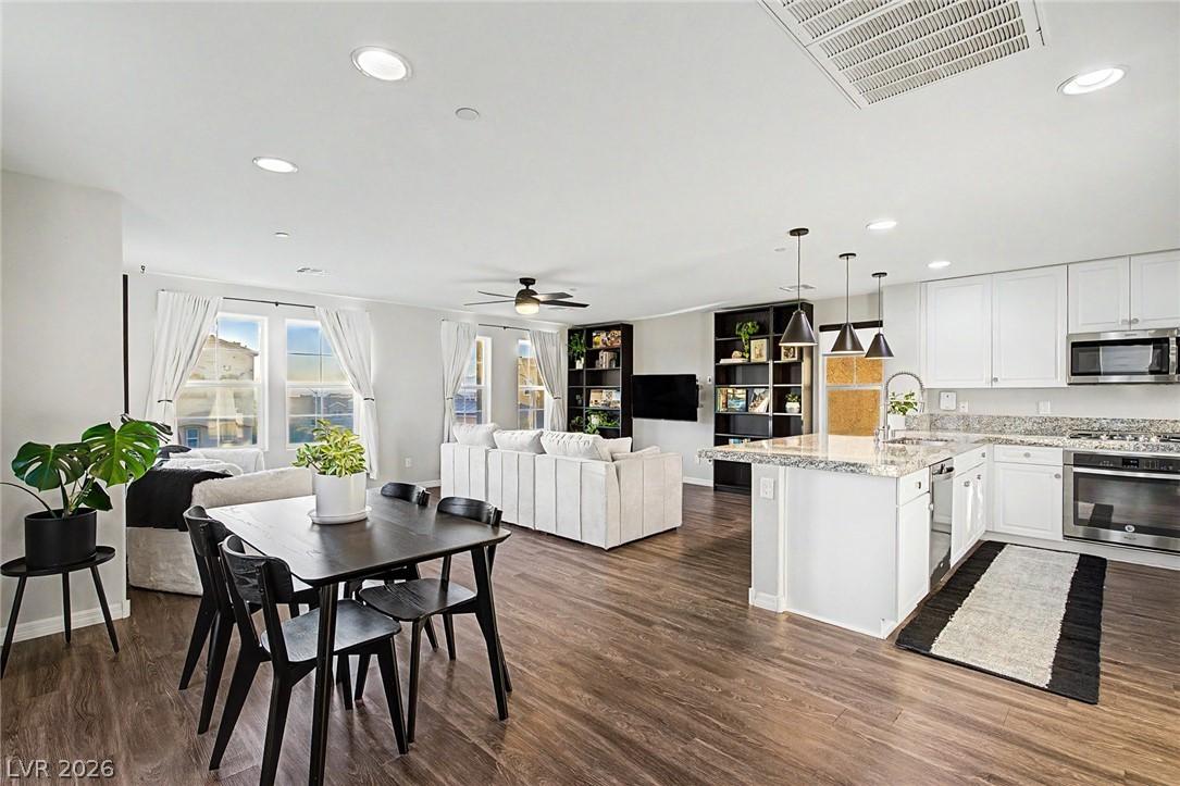 Image 1: An inviting open-concept area blends kitchen, dini