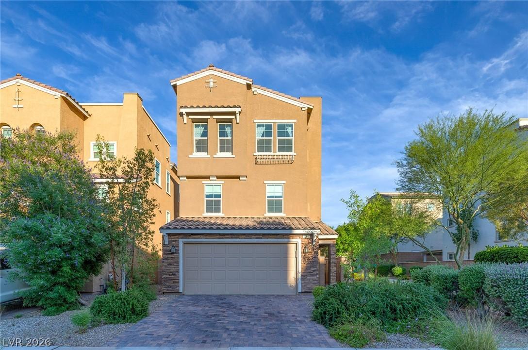 Image 2: This residence showcases a paved driveway and matu