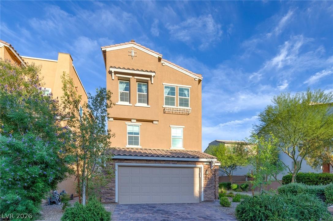 Image 3: This residence showcases a clean stucco exterior w