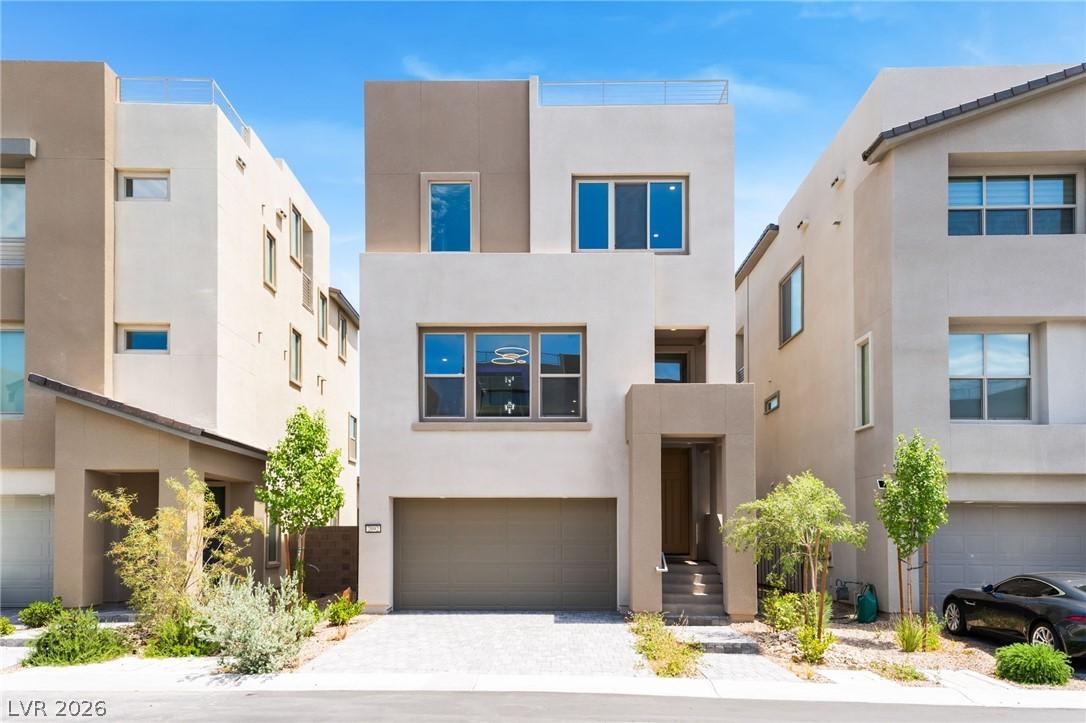 Image 3: This modern residence showcases a clean facade, of