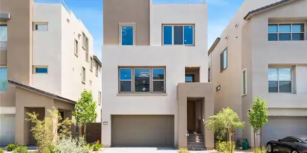 Image 3: This modern residence showcases a clean facade, of