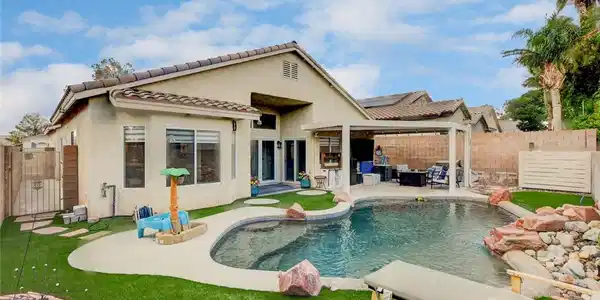 Image 2: An inviting backyard oasis awaits with a sparkling