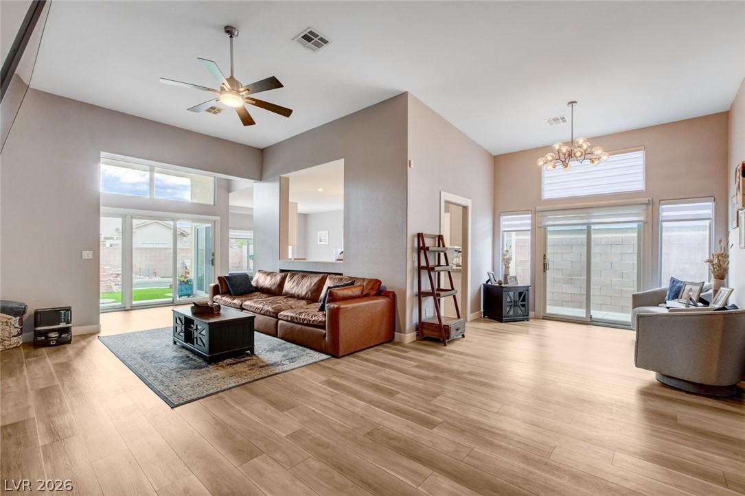 Image 4: Sun-filled living room featuring high ceilings and