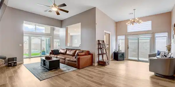 Image 4: Sun-filled living room featuring high ceilings and