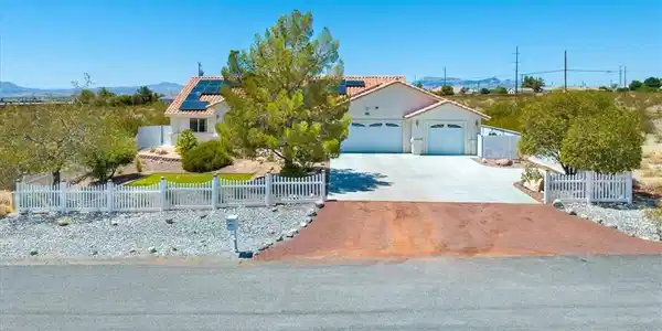 Image 4: A desert oasis with solar panels, a large driveway
