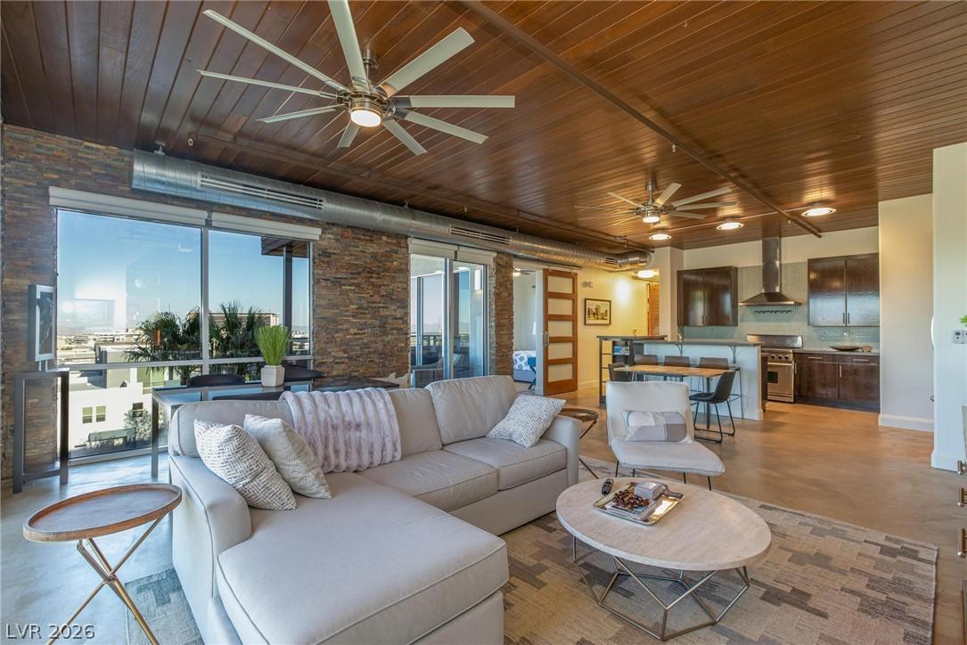 Image 2: An open-concept living space with exposed brick, l