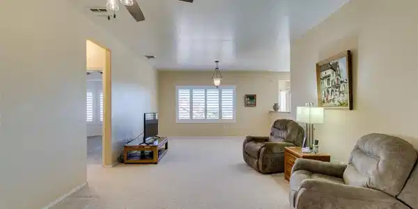 Image 2: An open living area features comfortable plush car