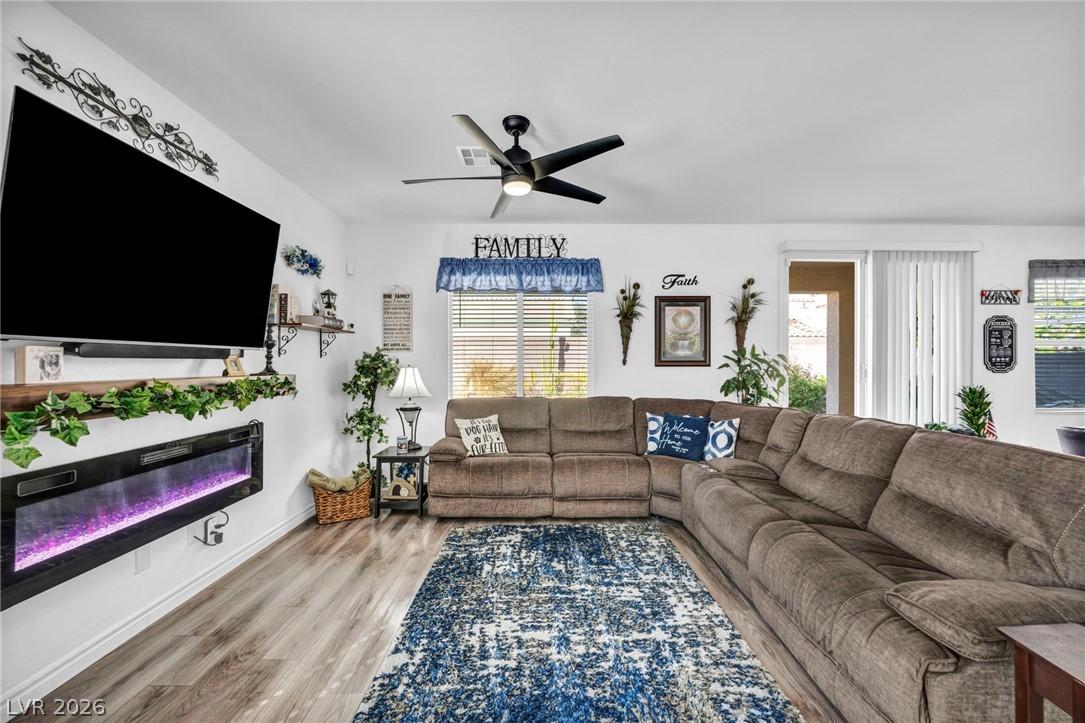 Image 2: Living area with light wood-style flooring, ceilin