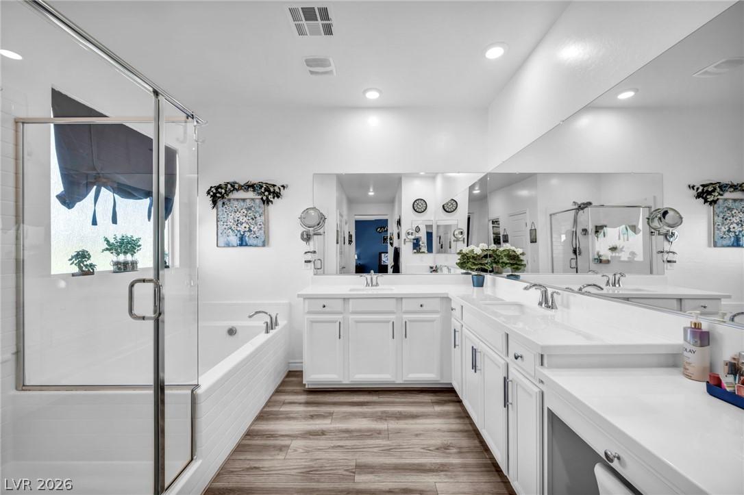 Image 3: Bathroom with a stall shower, double vanity, a gar