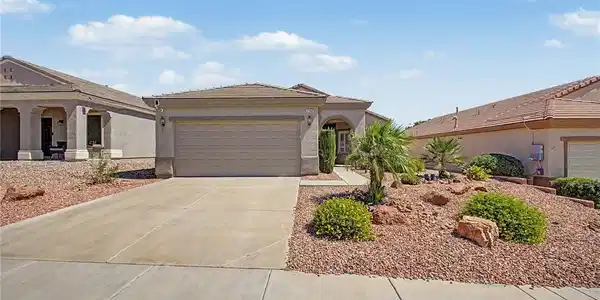 Image 4: A desert oasis with a paved driveway and low-maint