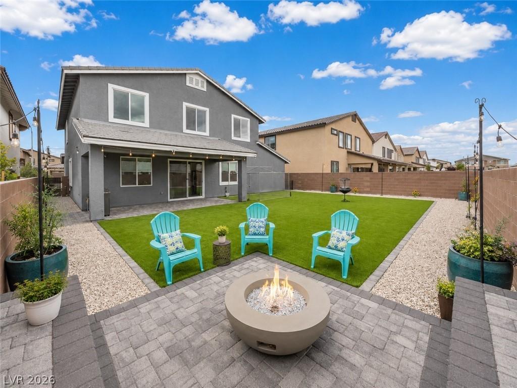 Image 1: A private backyard oasis features a fire pit, pati