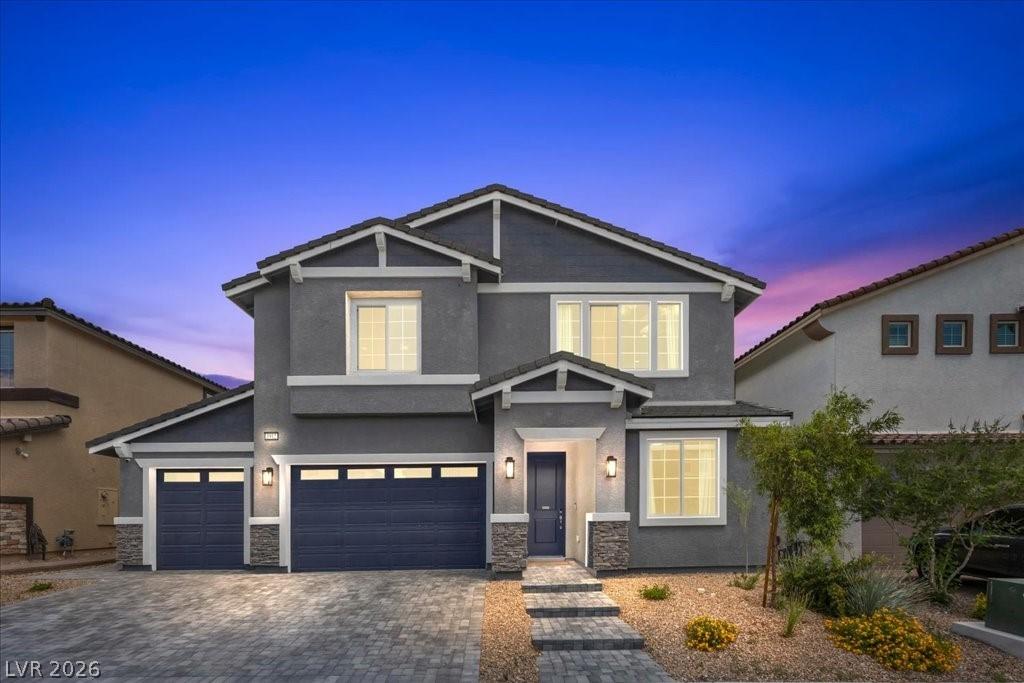 Image 2: A striking gray two-story residence with dark blue