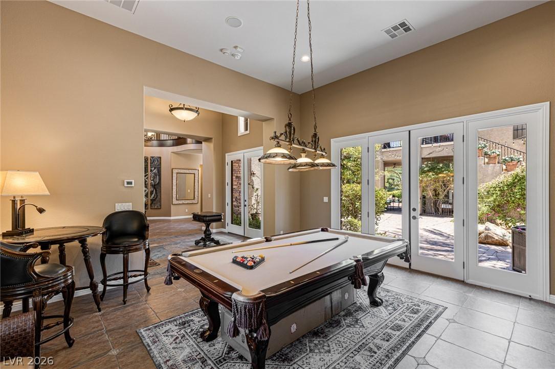 Image 4: Spacious pool room featuring a beautiful fireplace