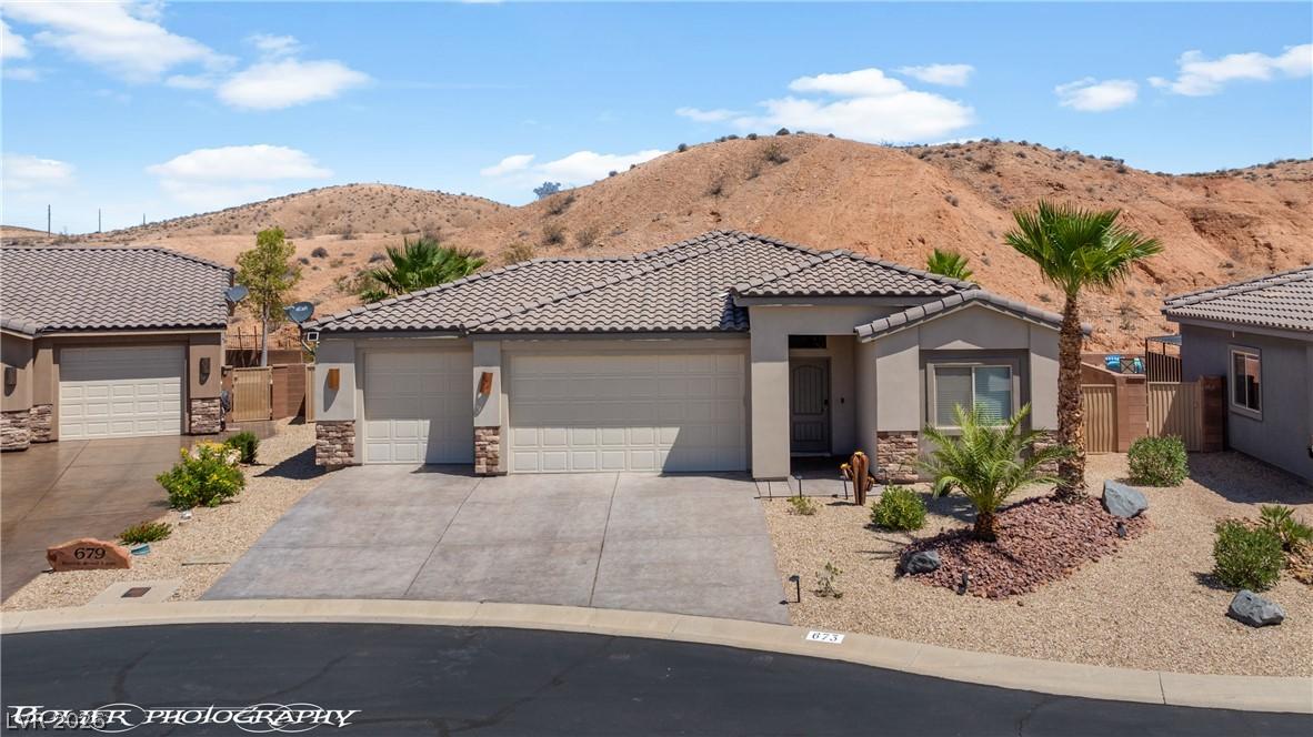 Image 2: Desert landscaping enhances this appealing propert