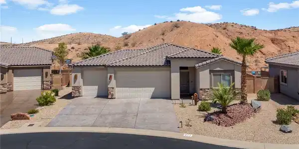Image 2: Desert landscaping enhances this appealing propert