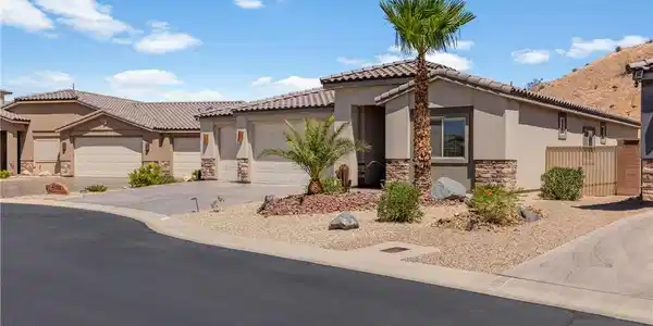Image 4: A desert oasis with stucco and stone construction,
