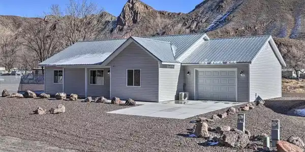 Image 2: A striking modern ranch-style home set against a r