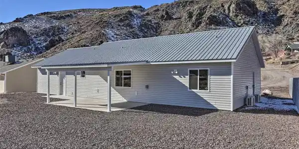 Image 3: Home with a metal roof and a covered patio, nestle