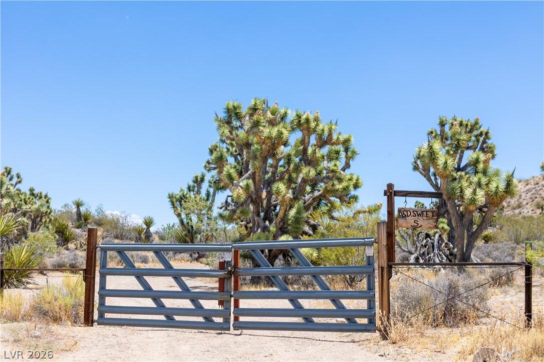 Image 2: A private gated entry opens to a desert landscape,