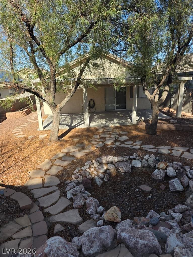 Image 2: An inviting backyard retreat features a fire pit,