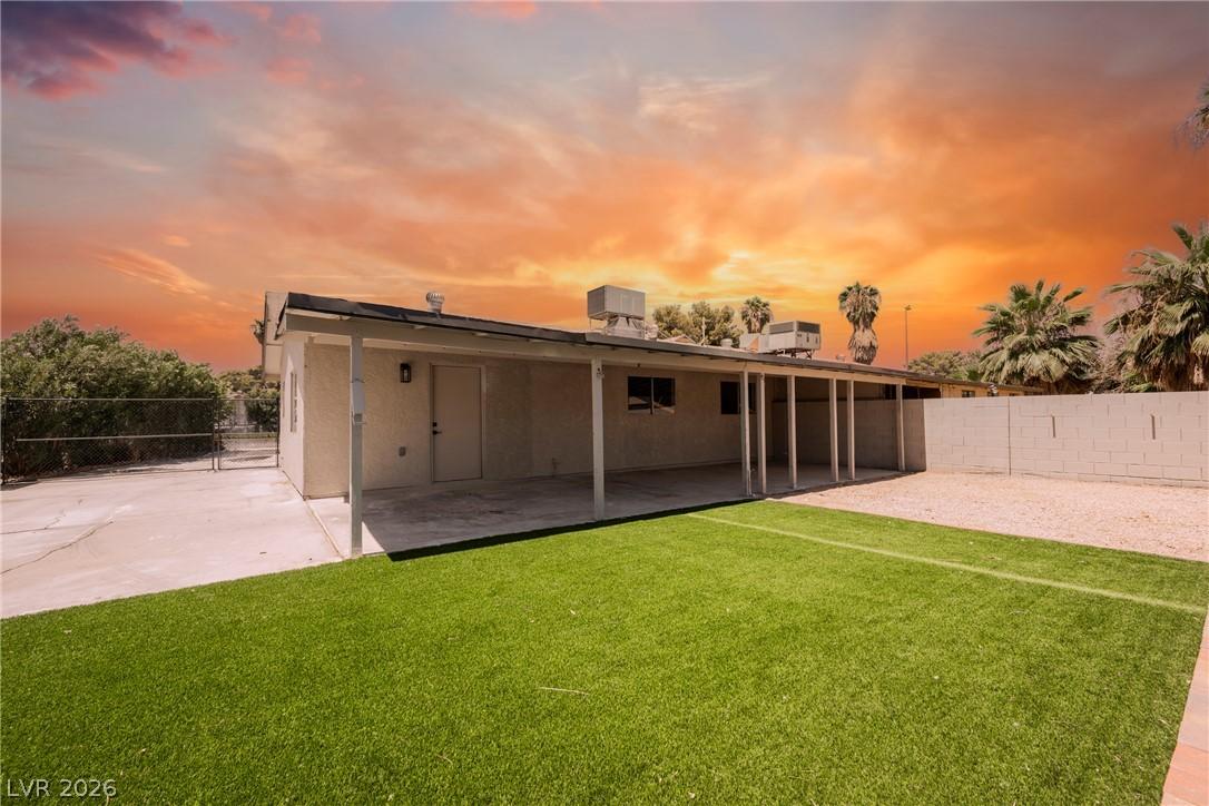 Image 4: A spacious covered patio overlooks a well-maintain