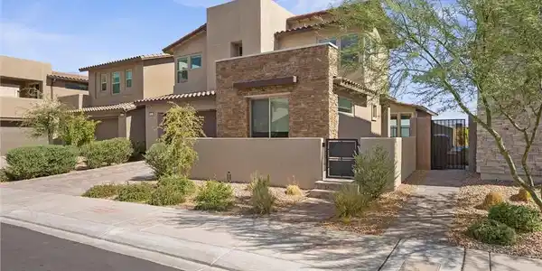 Image 4: Textured stone accents and smooth stucco define th
