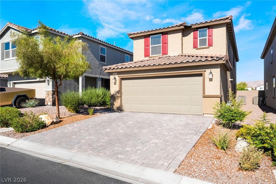 Image 2: A welcoming facade presents a neatly paver drivewa