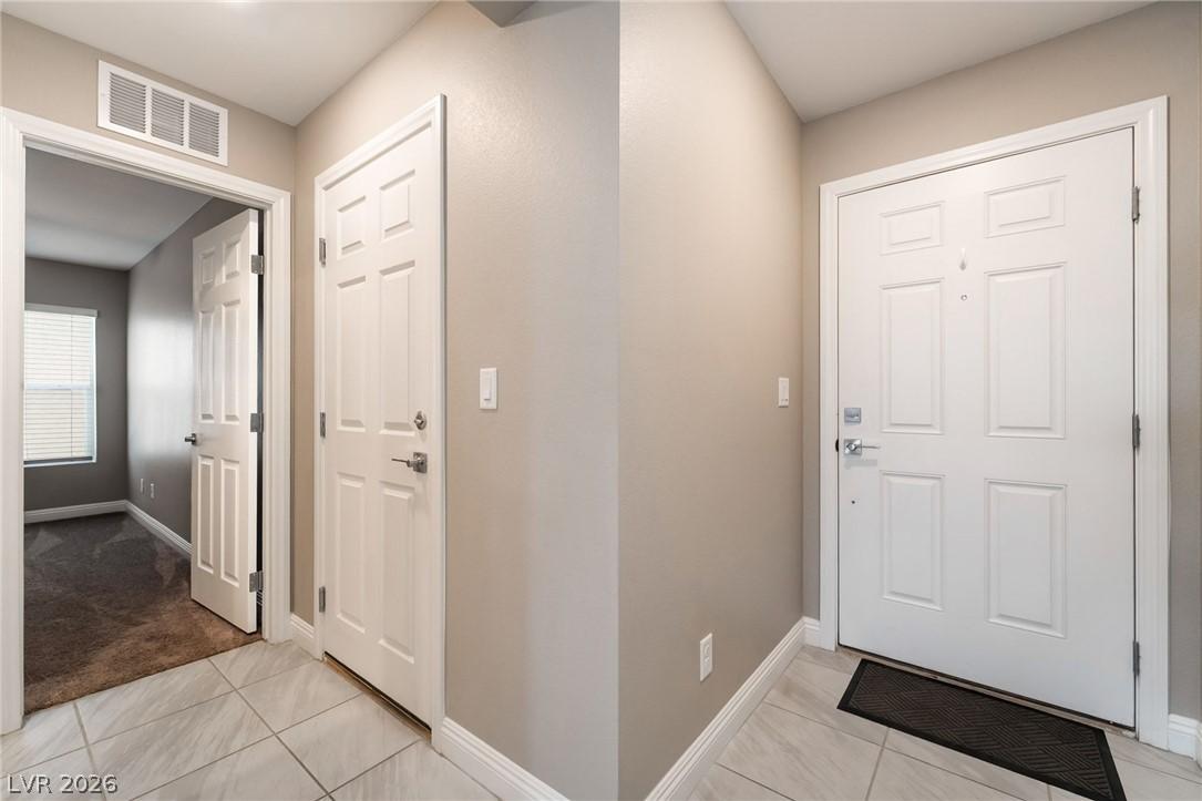 Image 4: A welcoming entryway with tile flooring leads to i