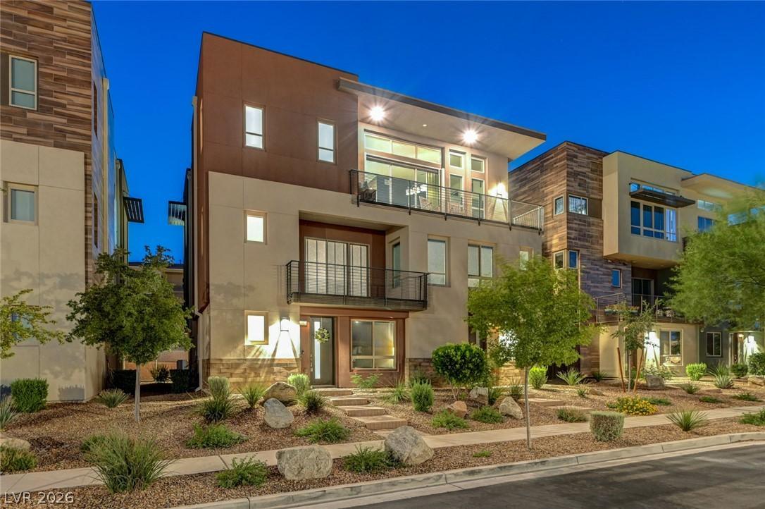 Image 1: Modern architecture with expansive windows illumin