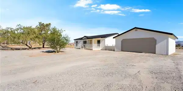Image 2: A spacious home with a separate garage structure,