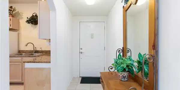 Image 4: A welcoming arched entryway leads past the kitchen