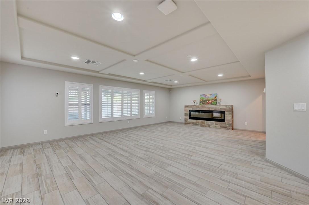 Image 3: A spacious great room featuring recessed lighting