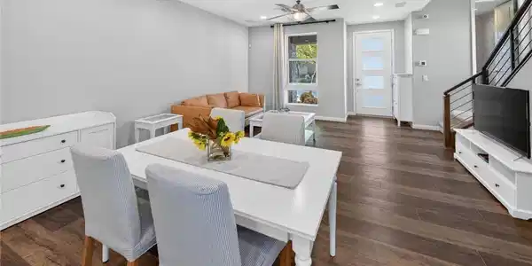 Image 3: Rich wood-look flooring and an open layout connect
