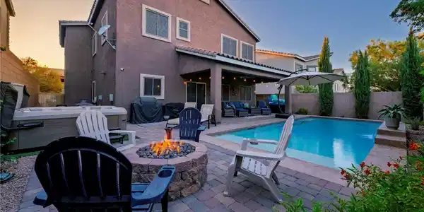 Image 2: An inviting backyard oasis features a shimmering p