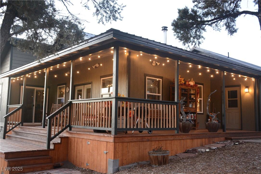 Image 3: Rear view of property with covered porch at Dusk