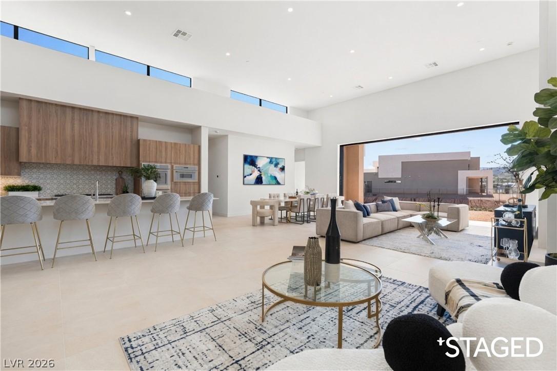Image 4: An open floorplan seamlessly connects the kitchen,